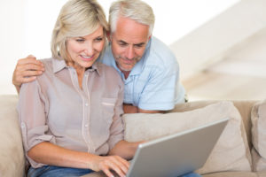 Couple On Laptop Home Comfort
